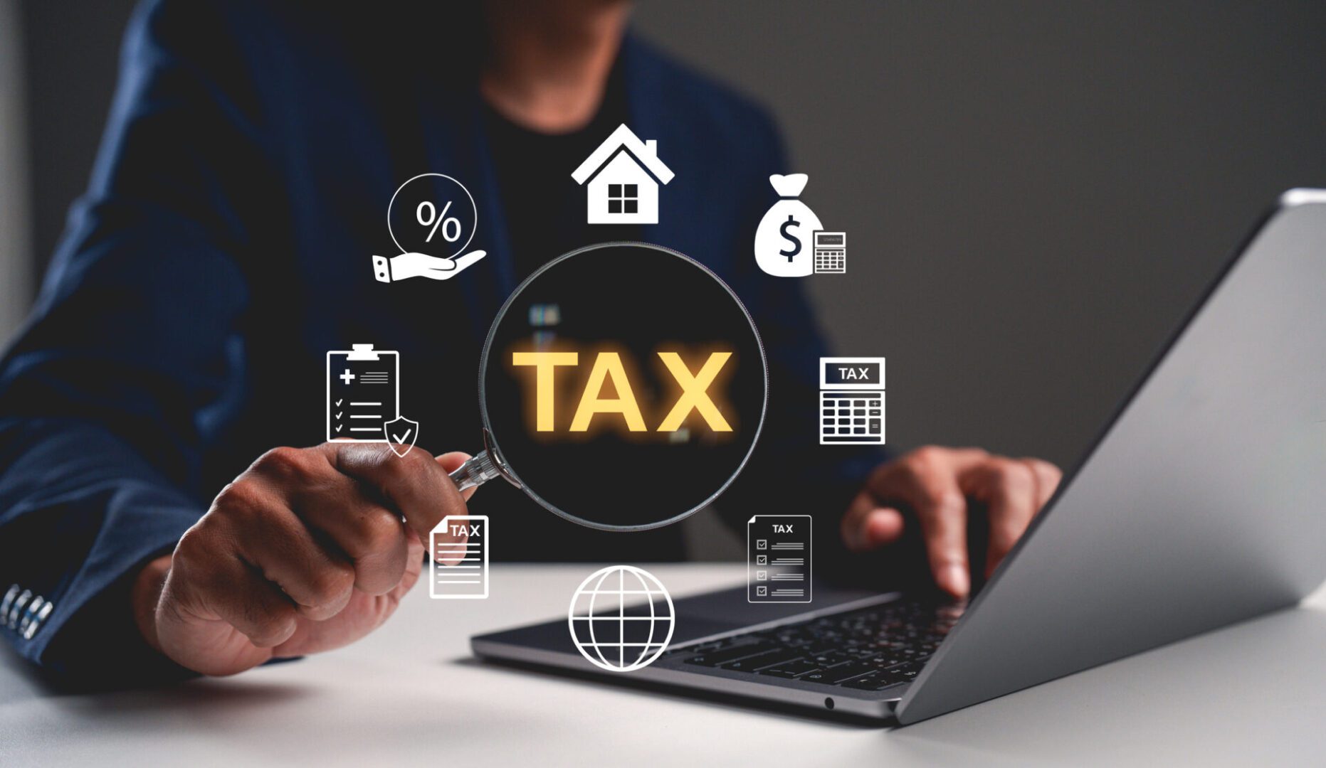 Person calculating taxes on a laptop with financial icons around.