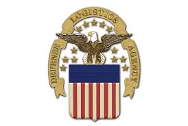 Emblem featuring an eagle, stars, and a shield with stripes.